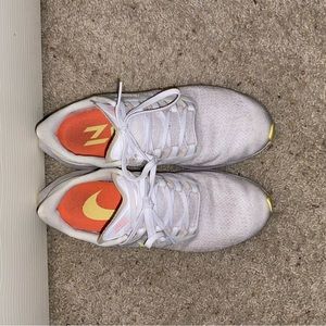 Nike running shoes with yellow bottom